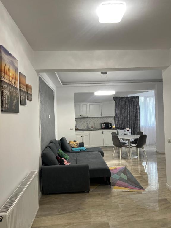 a living room with a couch and a table at Zig Zag Apartament in Constanţa