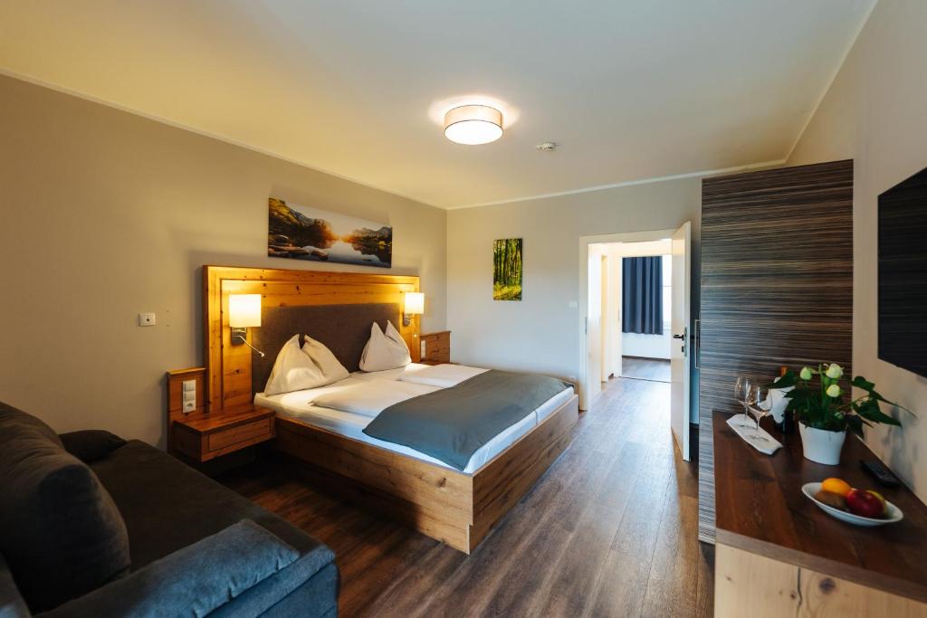 a hotel room with a bed and a couch at Familienhotel Trebesingerhof in Trebesing