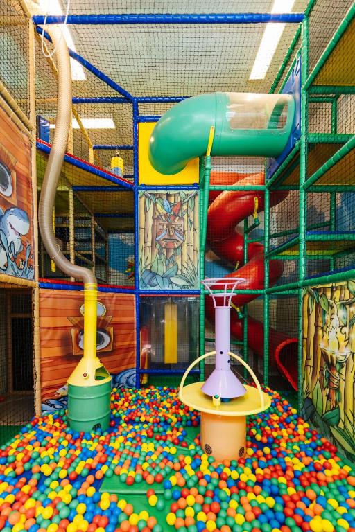 a play room filled with balls and a slide at Familienhotel Trebesingerhof in Trebesing