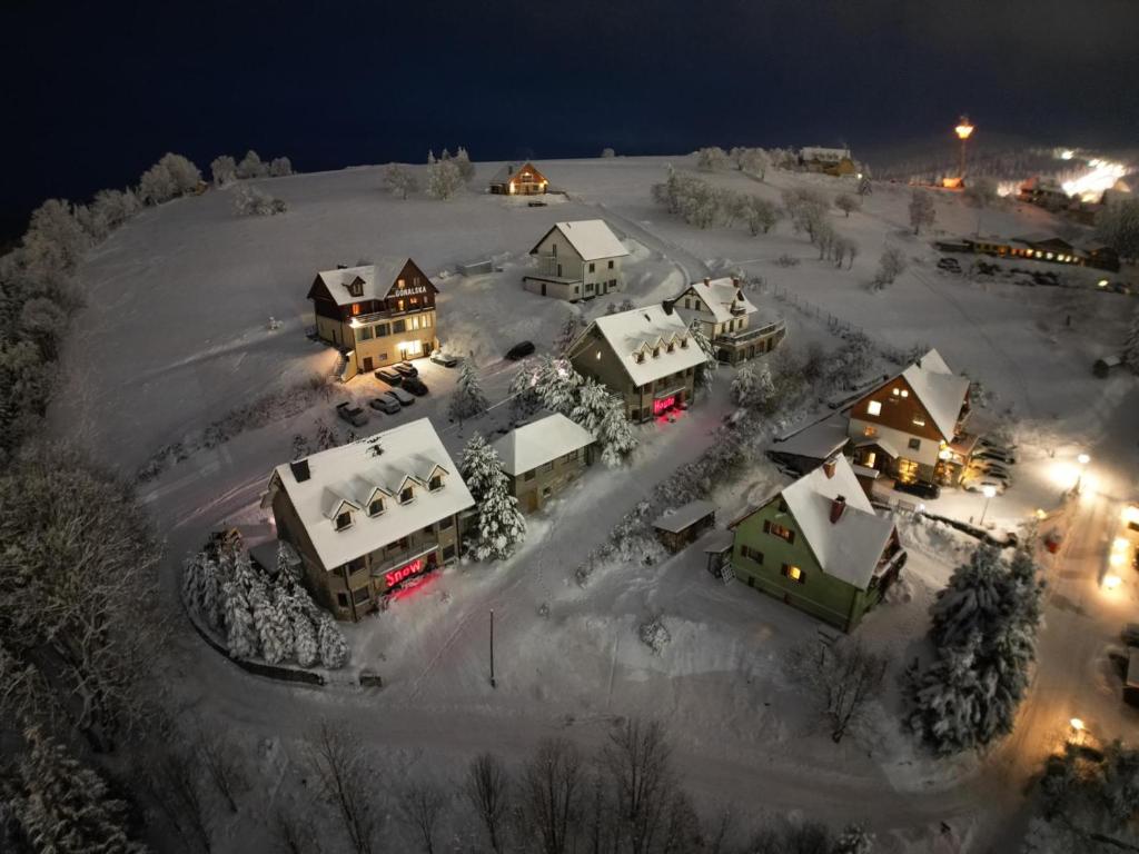 an aerial view of a town covered in snow at night at Apartamenty SnowHouse in Duszniki Zdrój