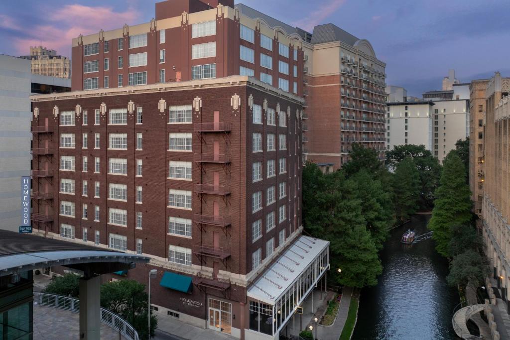 a building with a river in the middle of a city at Homewood Suites by Hilton San Antonio Riverwalk/Downtown in San Antonio