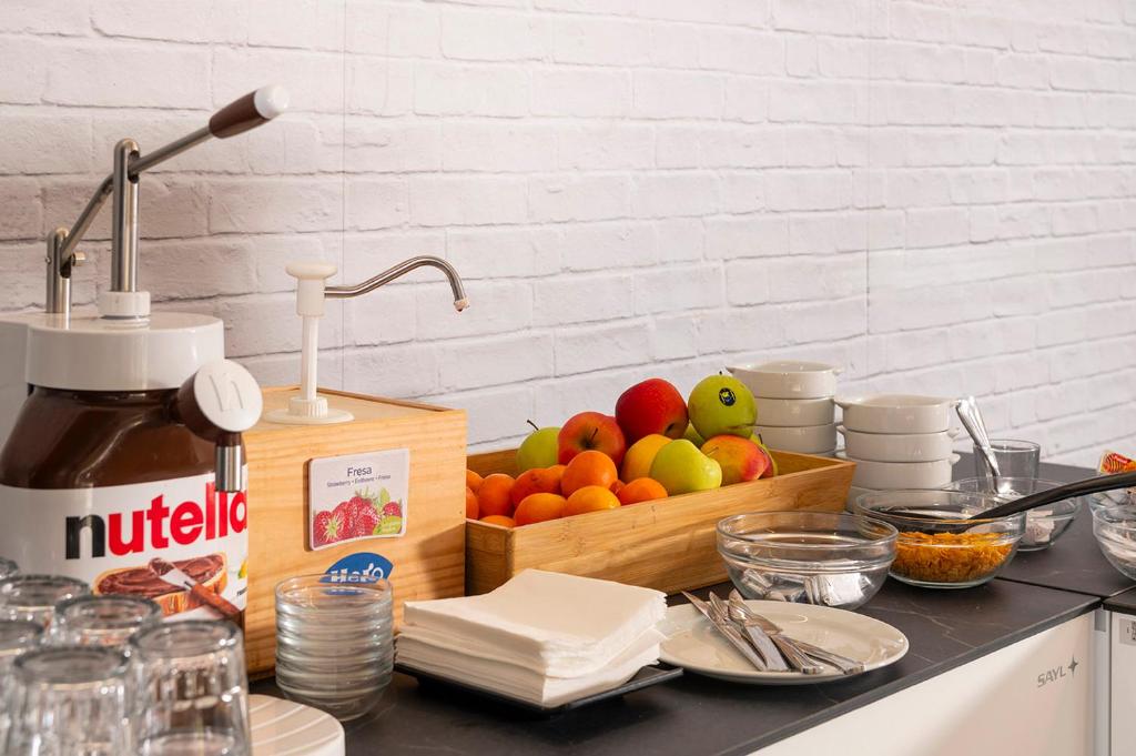 a kitchen counter with a cutting board with fruit in it at Apartaments Els Llorers in Lloret de Mar