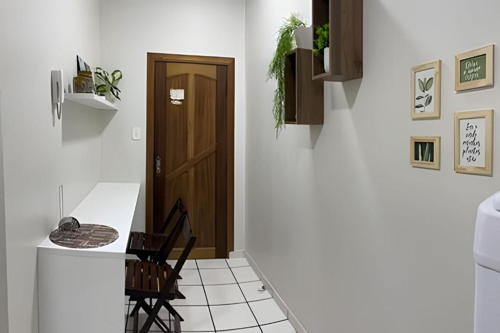 a kitchen with a door and a table and chairs at Umbelino Moradia in Santarém