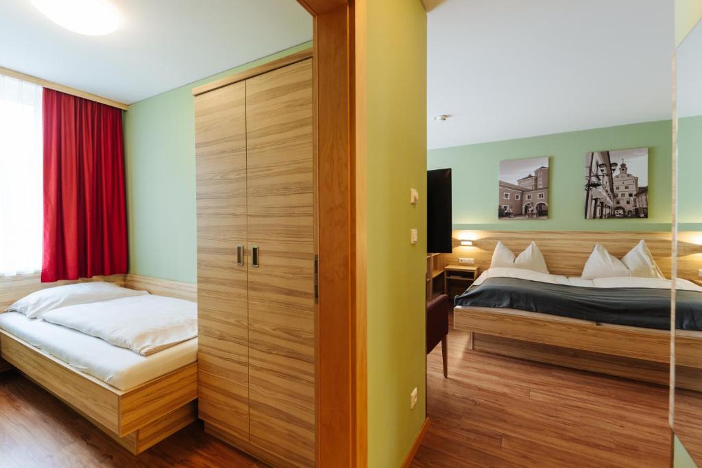 a bedroom with a bed and a sliding door at Familienhotel Trebesingerhof in Trebesing