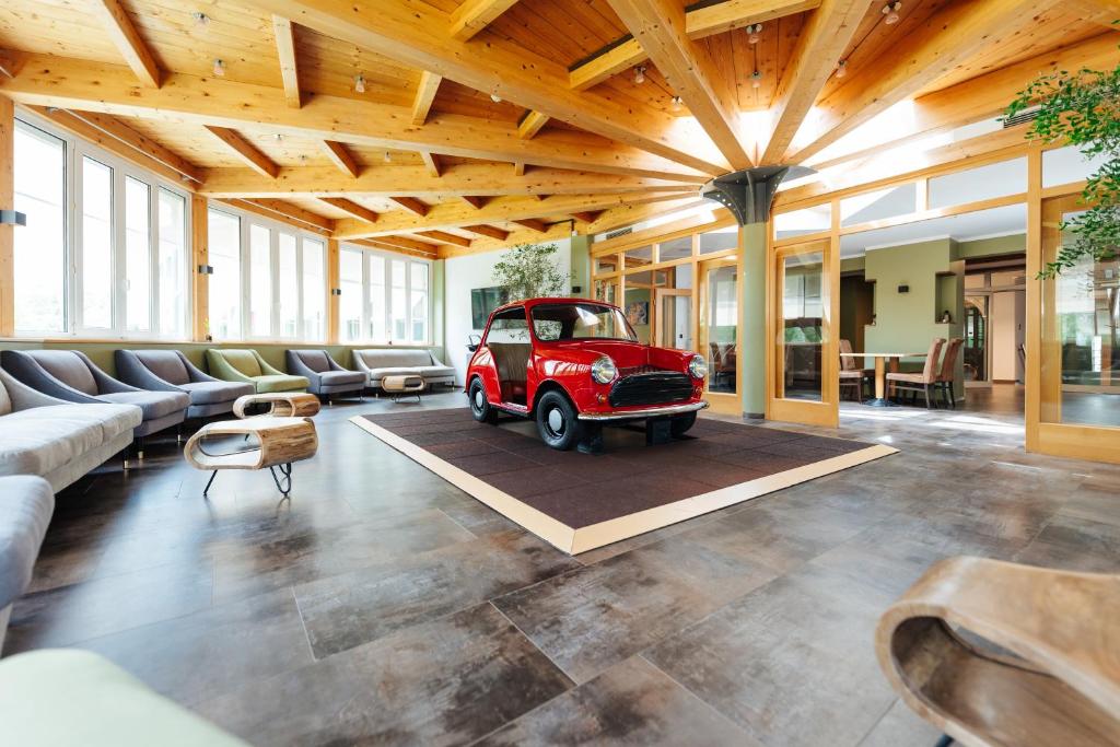 a living room with a red car in the middle at Familienhotel Trebesingerhof in Trebesing