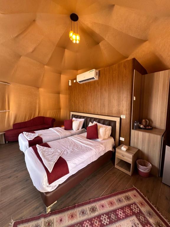 a bedroom with a large bed in a room with a ceiling at Sunset Gem _ Wadi Rum in Disah