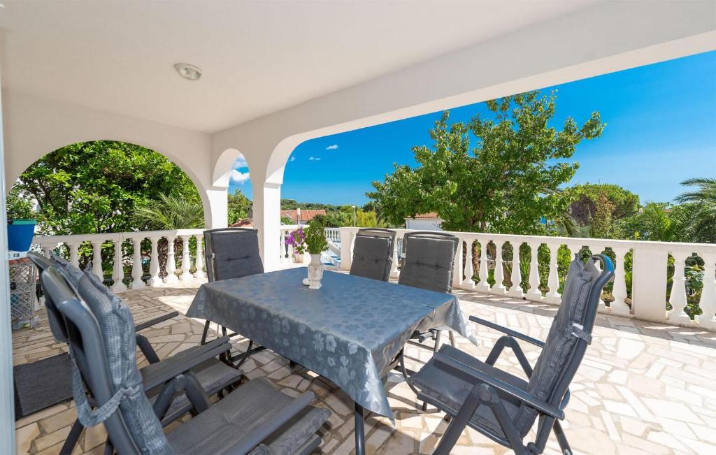 a patio with a table and chairs on a balcony at 2 Bedroom Lovely Apartment In Potocnica in Potocnica