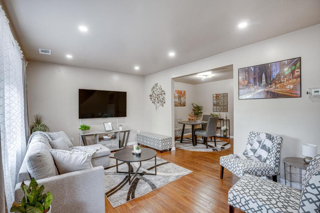 a living room with a couch and chairs and a tv at Charming Willow Grove Home with Patio and Fire Pit! in Willow Grove
