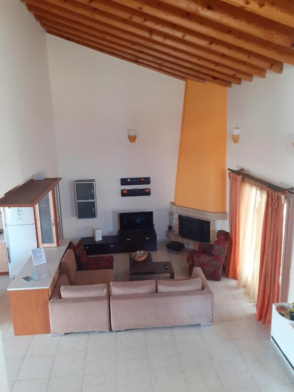 a living room with a couch and a table at Castelo Chalet Chios in Chios