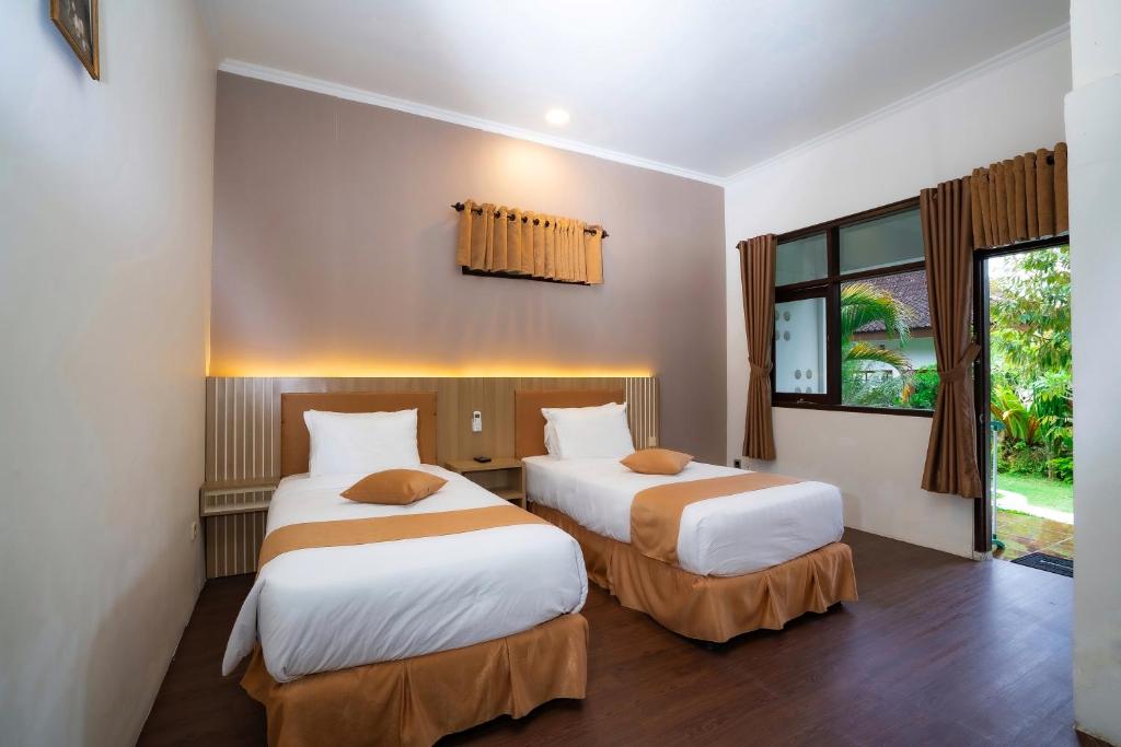 Postel nebo postele na pokoji v ubytování Nirvana Hotel Resort Tetebatu