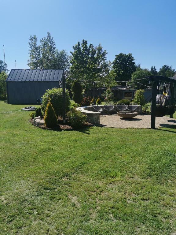 a park with a playground and a swing at Rietumi in Kolka