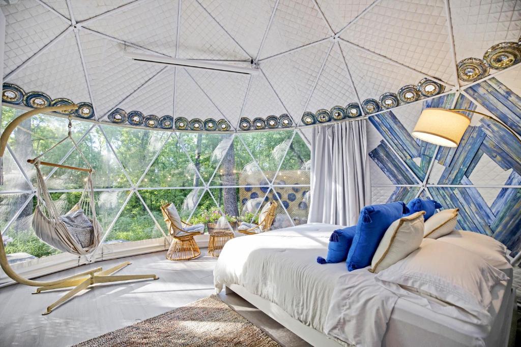 a bedroom with a large room with a bed and a large window at Dream Dome Getaway near Leesburg in Leesburg