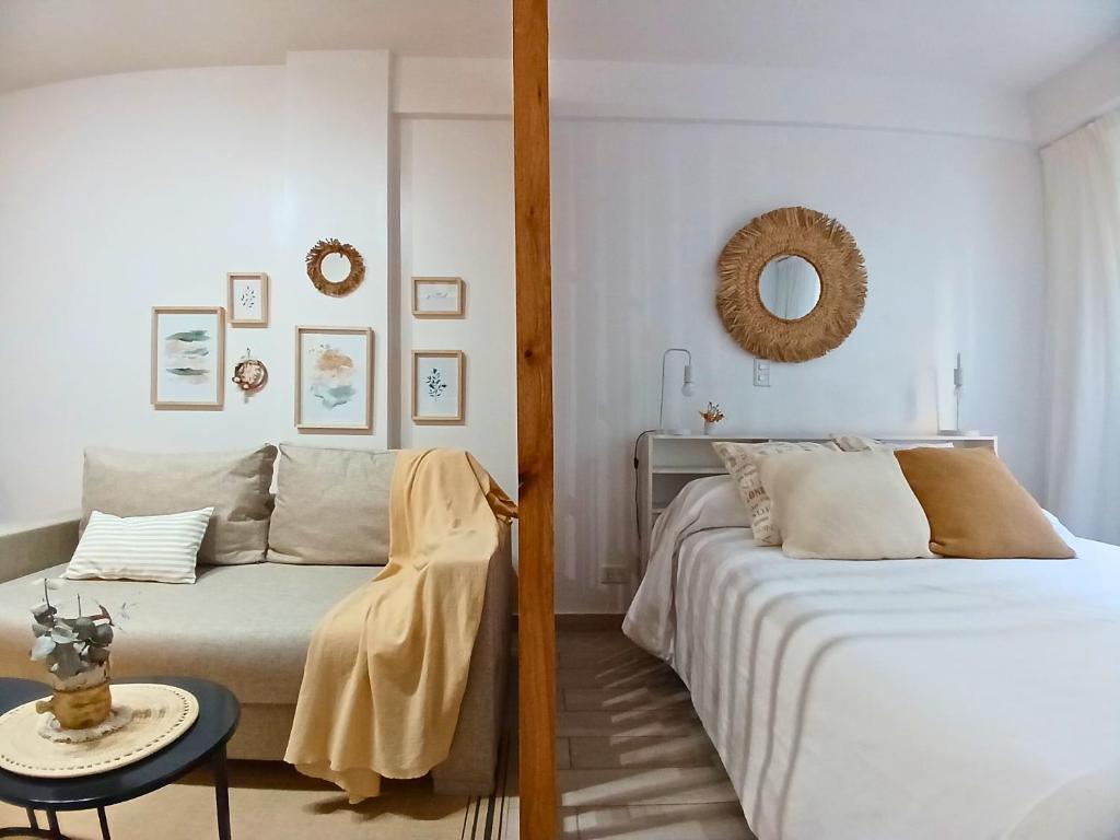 a bedroom with two beds and a mirror at Palermo Madison in Buenos Aires