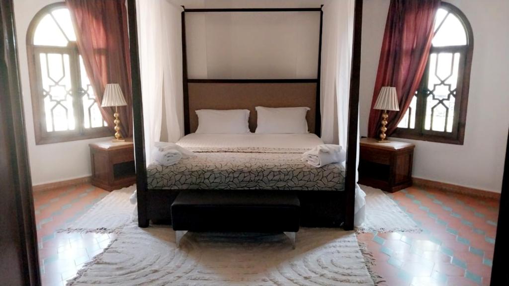 Postel nebo postele na pokoji v ubytování Las Palmeras Guest House