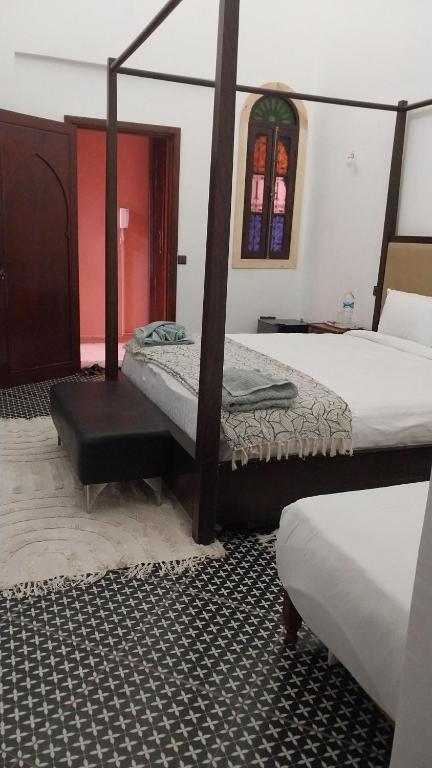Postel nebo postele na pokoji v ubytování Las Palmeras Guest House