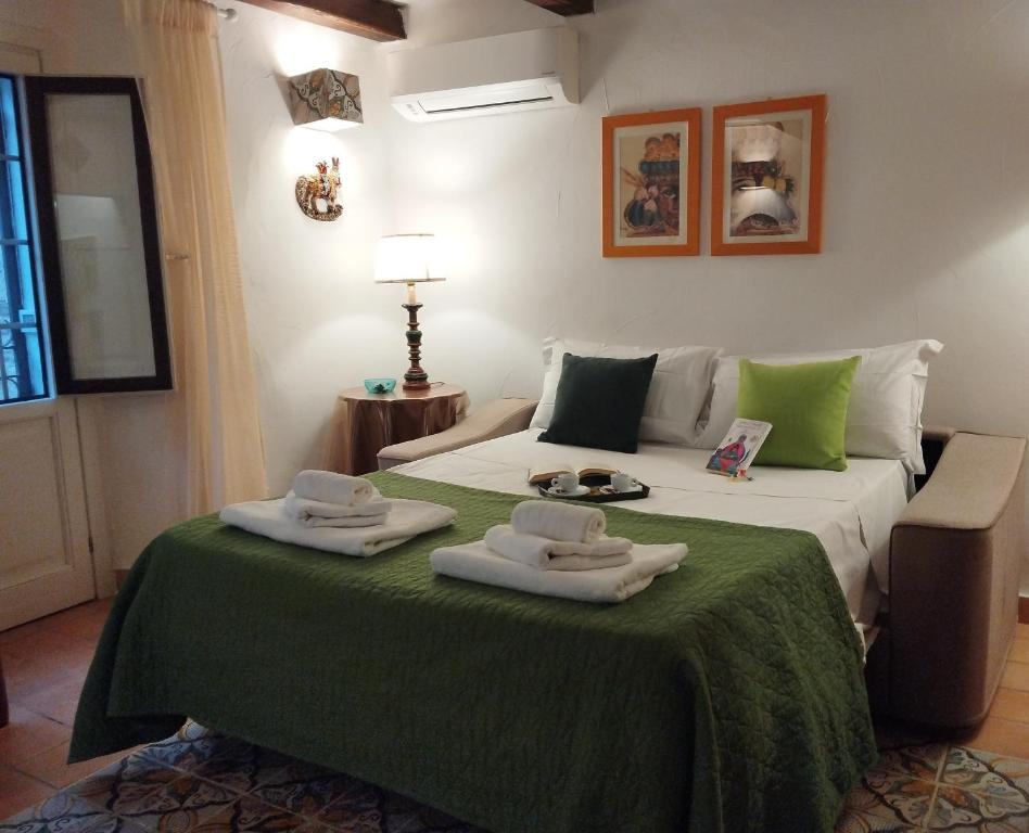 a hotel room with a bed with towels on it at Erice Appartamenti in Erice