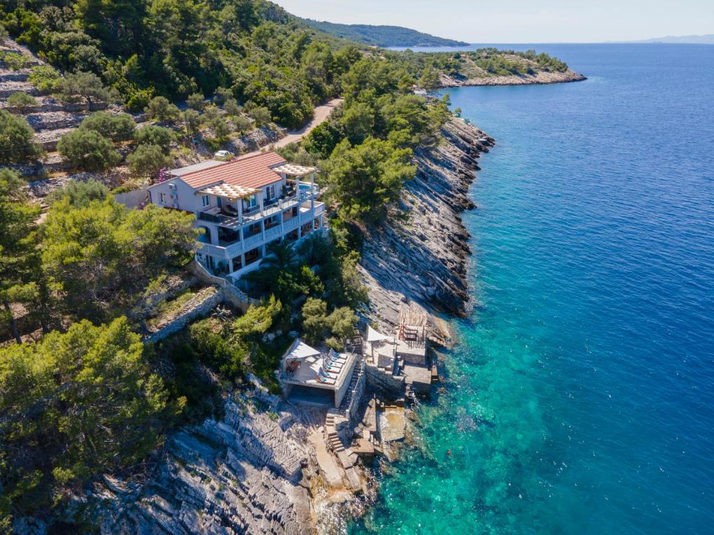 an aerial view of a house on a rocky island at Corcyra Nigra Apartment 2 in Blato