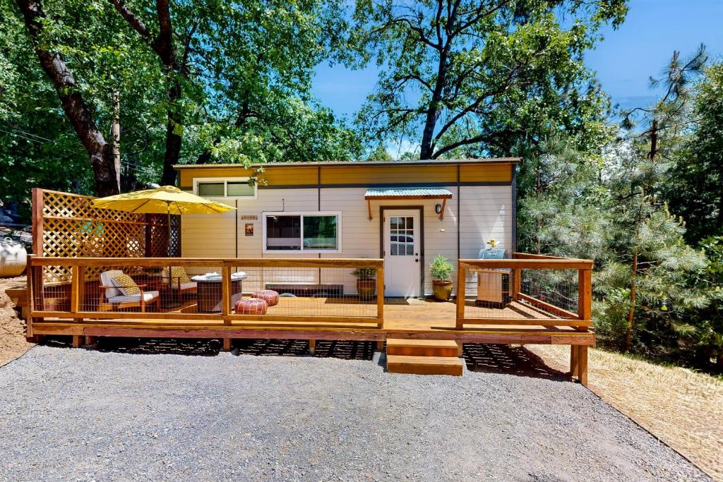 a tiny house with a porch and a patio at Nature's Nook Mountain Retreat in Sonora