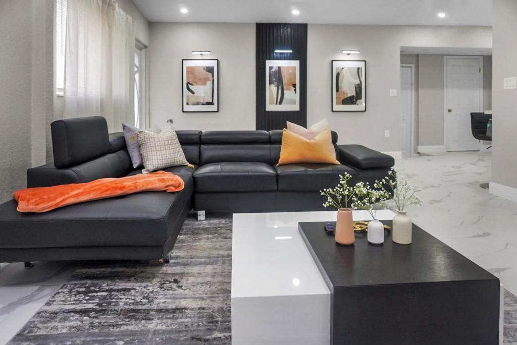 a living room with a black couch and a table at Miami Luxury Home Rental in Miami