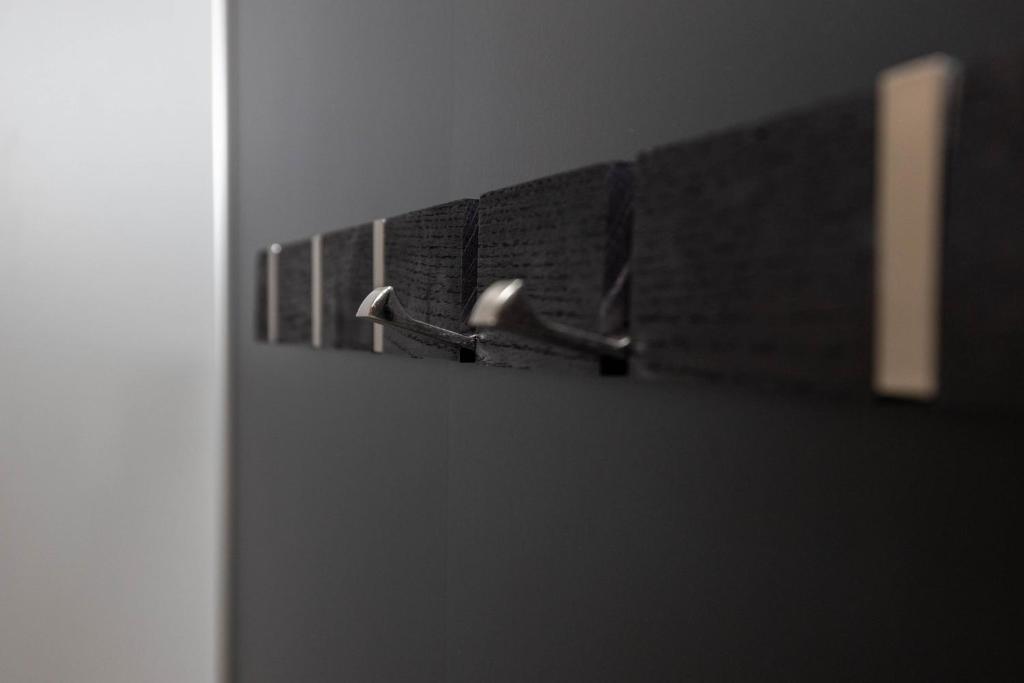 a row of black towels on a rack in a bathroom at Dis Cottages in Grundarfjordur
