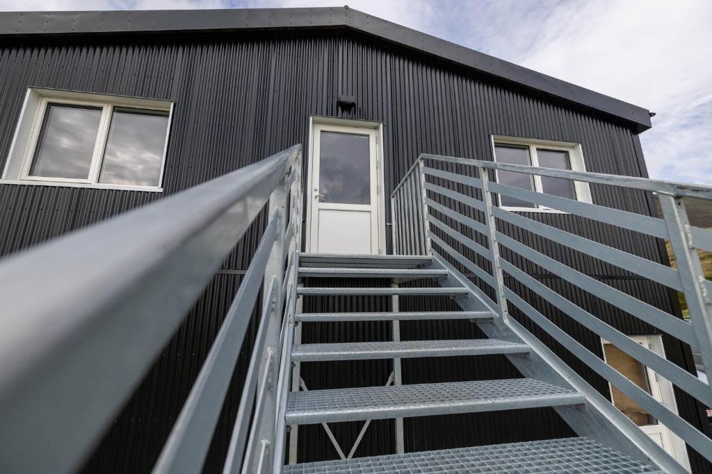 a staircase leading up to a building with a door at Dis Cottages in Grundarfjordur