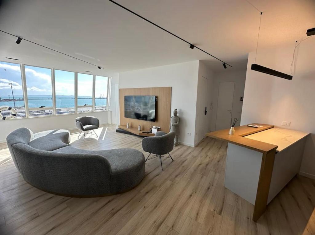 a living room with a couch and a table at Yacht Concept Durrës Marina in Durrës