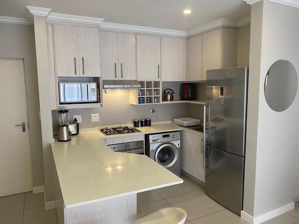 a kitchen with a stainless steel refrigerator and a dishwasher at The little Falls Lifestyle Estate in Roodepoort
