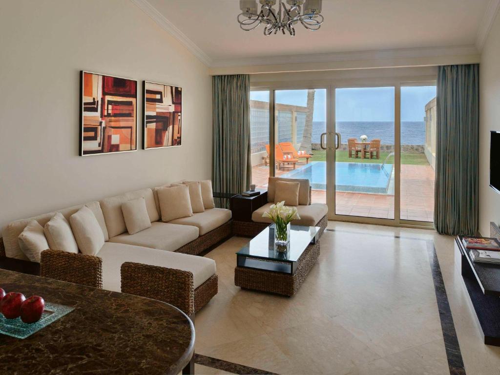 a living room with a couch and a table at Mövenpick Al Nawras Jeddah - Family Resort in Jeddah