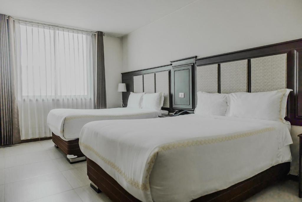 Postel nebo postele na pokoji v ubytování Hotel D'Carlo Class
