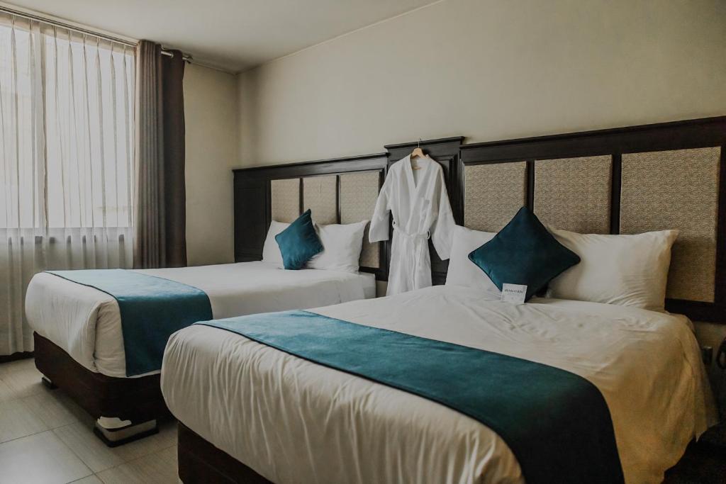 Postel nebo postele na pokoji v ubytování Hotel D'Carlo Class