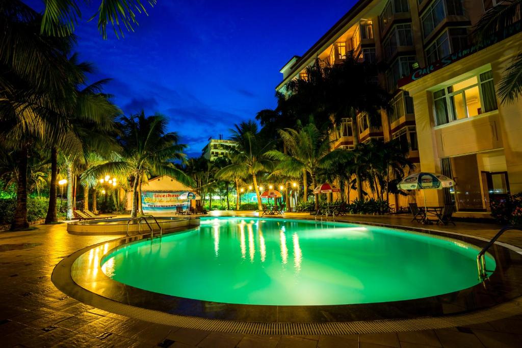 a swimming pool in a resort at night at Saigon Kimlien Resort Cualo in Cửa Lò