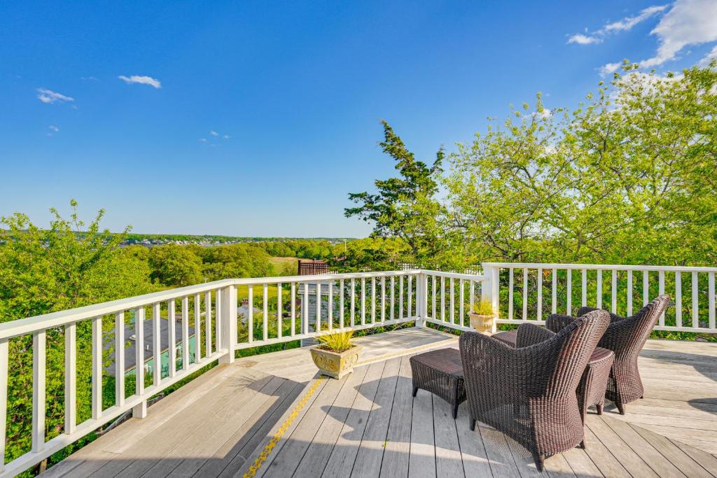 a deck with two chairs and a table at Elegant Gloucester Beach Getaway with Ocean Views! in Gloucester
