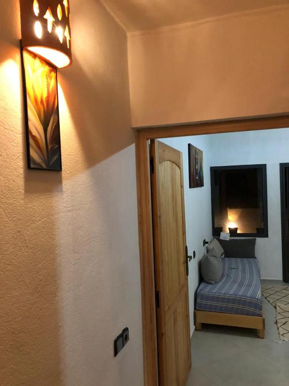 a room with a bedroom with a bed and a door at apartment vue Mer in Agadir