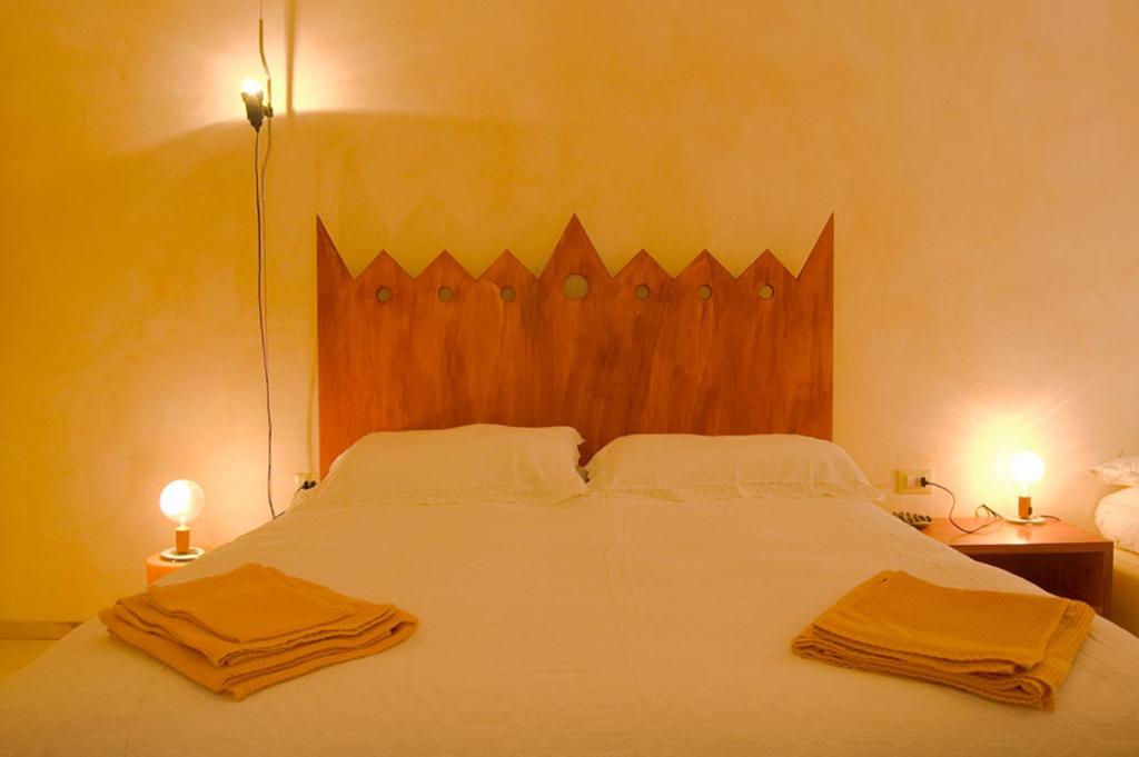 a bedroom with a large bed with two towels on it at La Tata B&B in Lerici