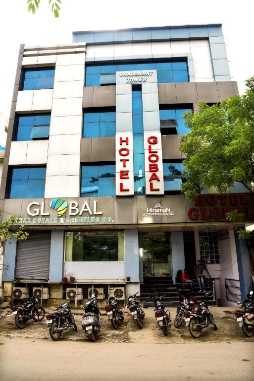 a group of motorcycles parked in front of a building at Hotel Global Inn in Udaipur
