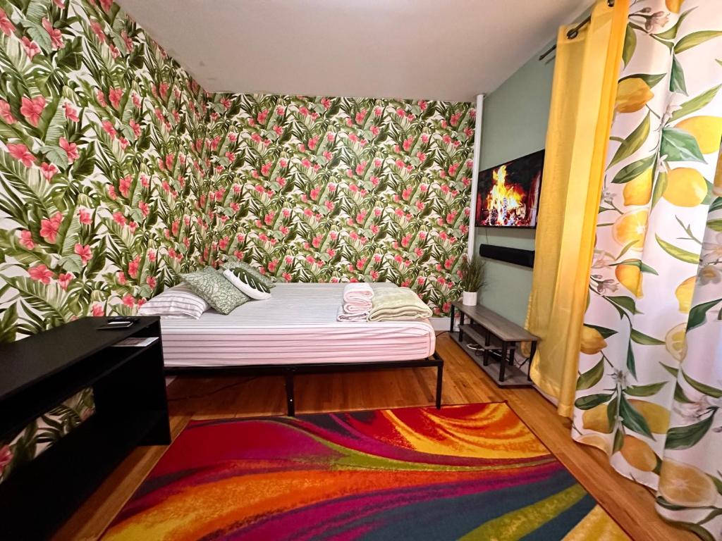 a bedroom with a bed with a floral wallpaper at queen size room with shared bathroom in New York