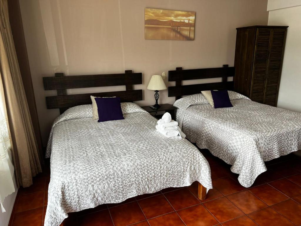 Postel nebo postele na pokoji v ubytování Hotel Arenal by Regina