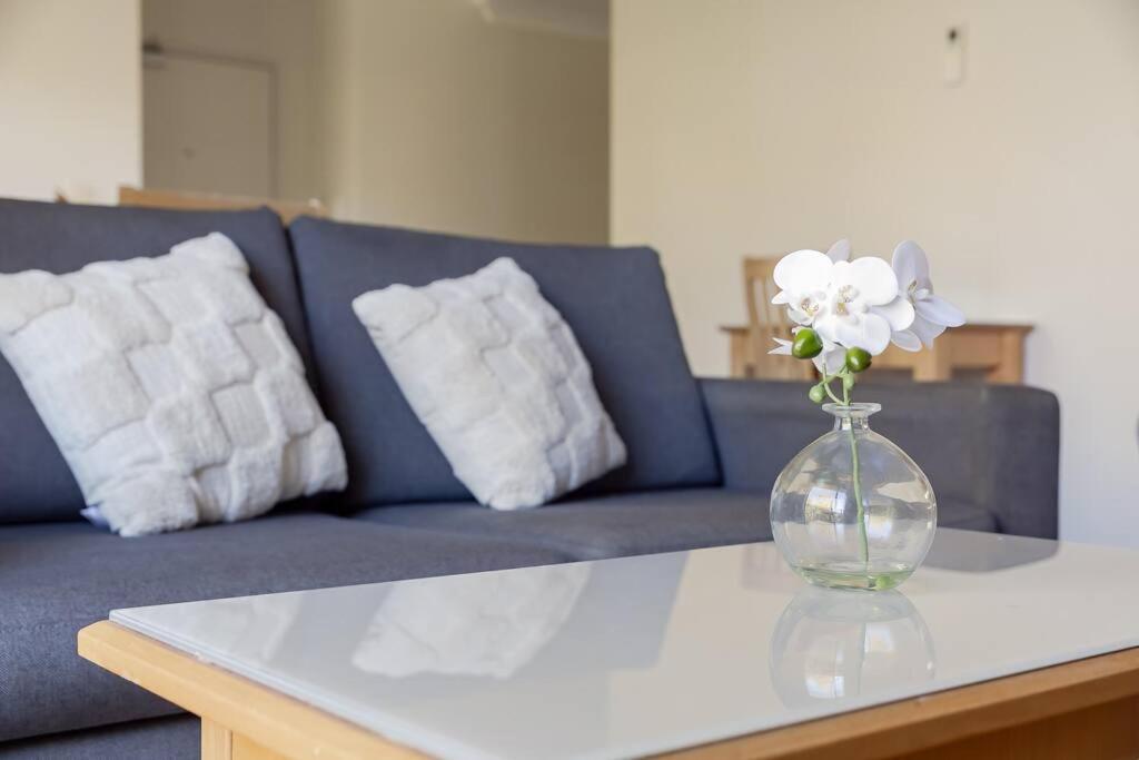 a vase with white flowers sitting on a table at 2X1 Comfy Apartment in Perth CBD in Perth