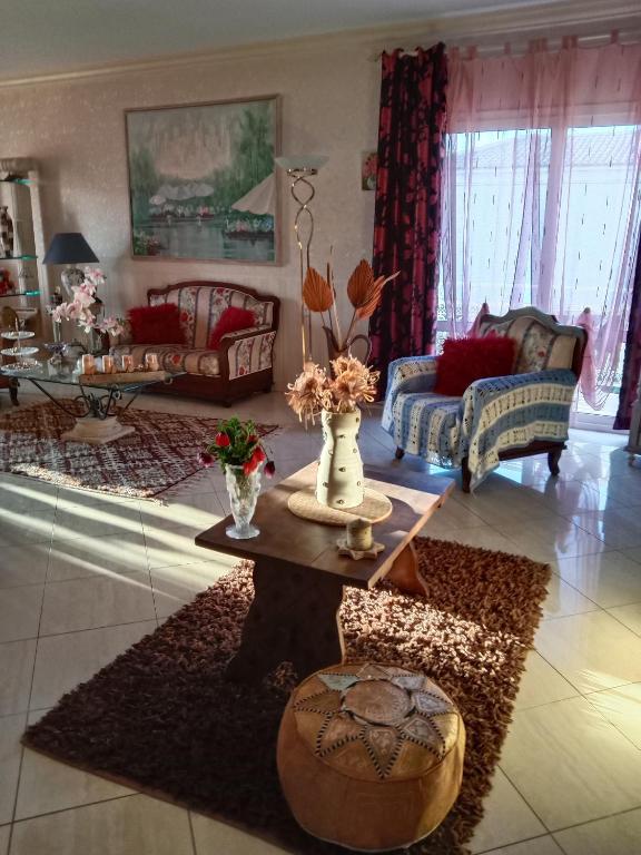 a living room with a couch and a table at 40 Allée Le Chêne in Bastia