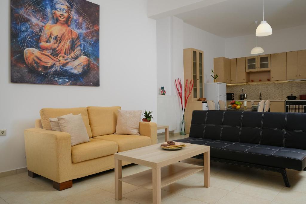 a living room with a couch and a table at My AVRA, flat in Agioi Apostoloi Chania in Daratso