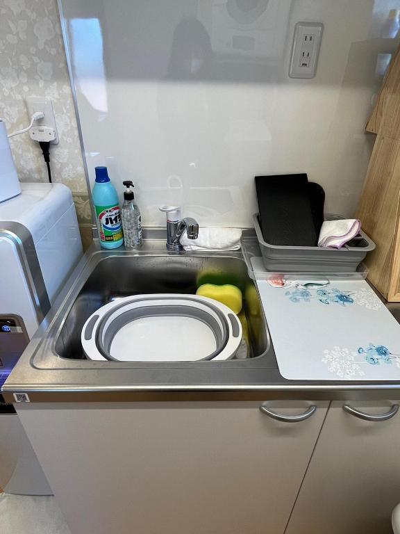 a kitchen sink with a plate in it at DainHostel2 in Tokyo