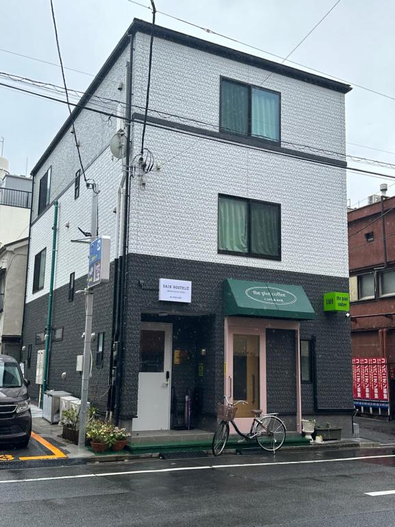 a bike parked in front of a building at DainHostel2 in Tokyo
