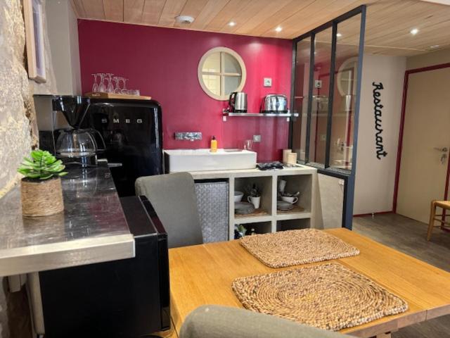 a kitchen with a table and a dining room at Le STUDIO DUO CITE MEDIEVAL SARLAT in Sarlat-la-Canéda