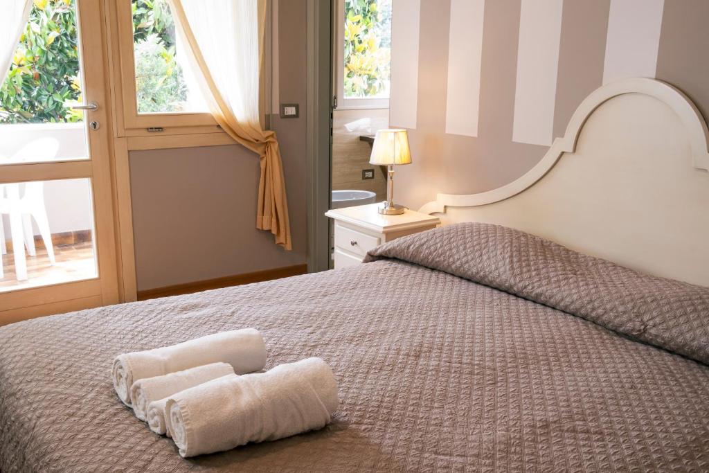 a bedroom with a bed with two towels on it at Hotel Volta in Padova