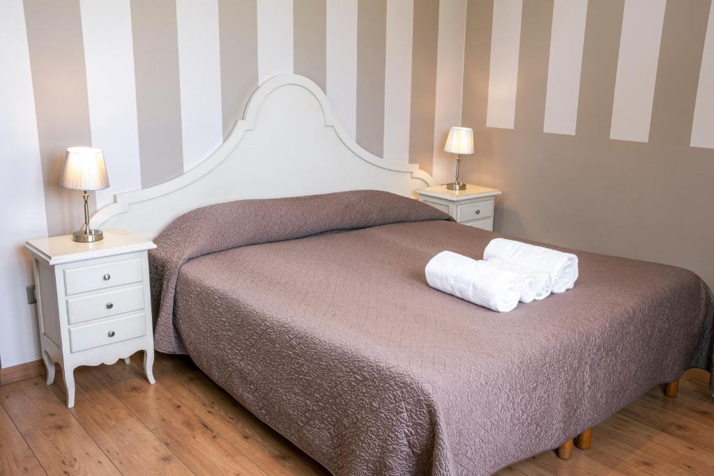 Postel nebo postele na pokoji v ubytování Hotel Volta