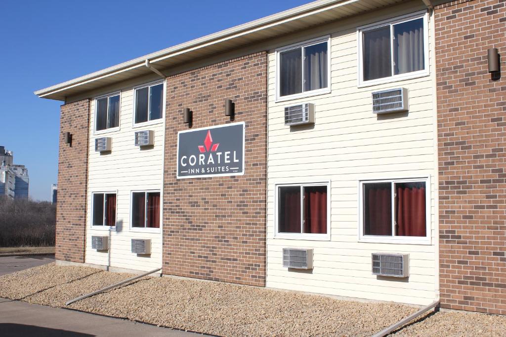 a building with a sign on the side of it at Coratel Inn & Suites by Jasper Hastings in Hastings