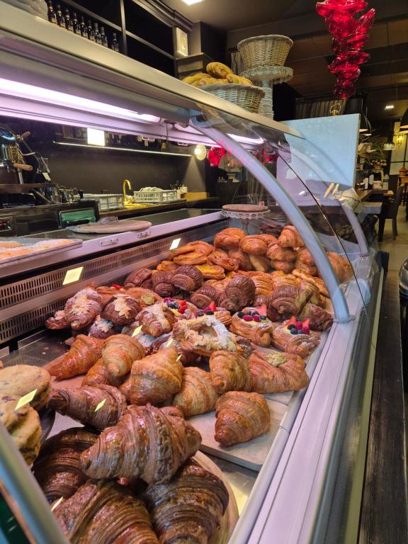 a display case in a bakery with chickens and meat at Elena House Apartments in Viareggio