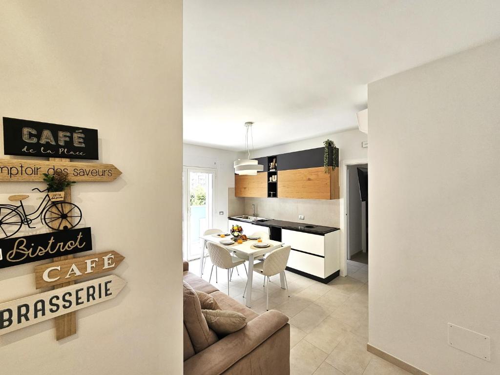a kitchen and a living room with a couch and a table at Grey House 4 100mt dal mare in Tortoreto Lido