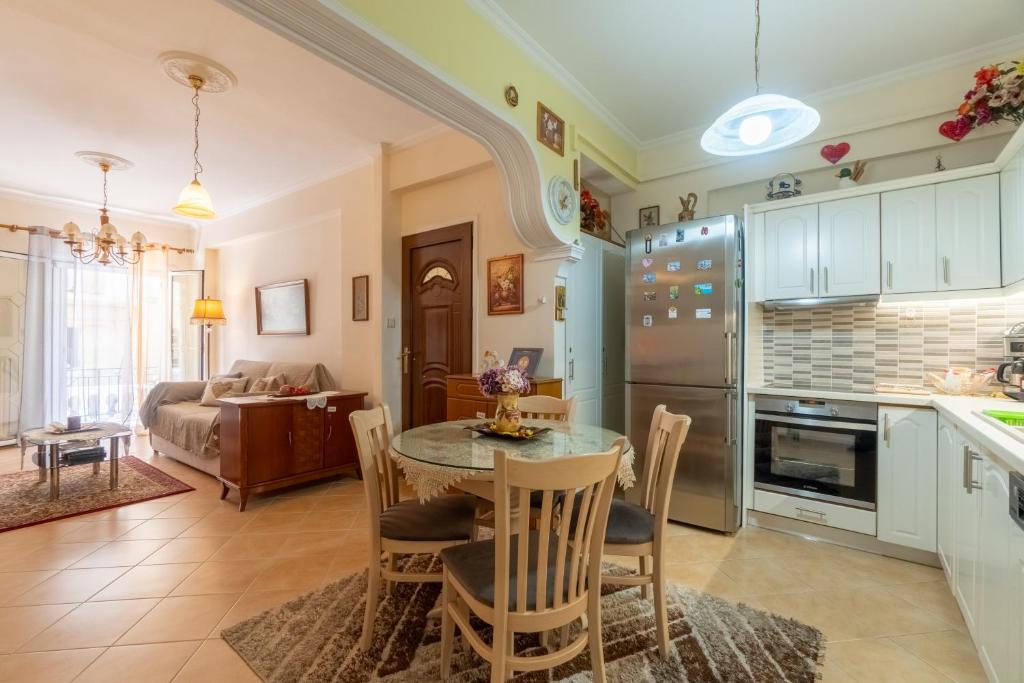 a kitchen and living room with a table and chairs at Doris House by GuestCorfu in Corfu Town