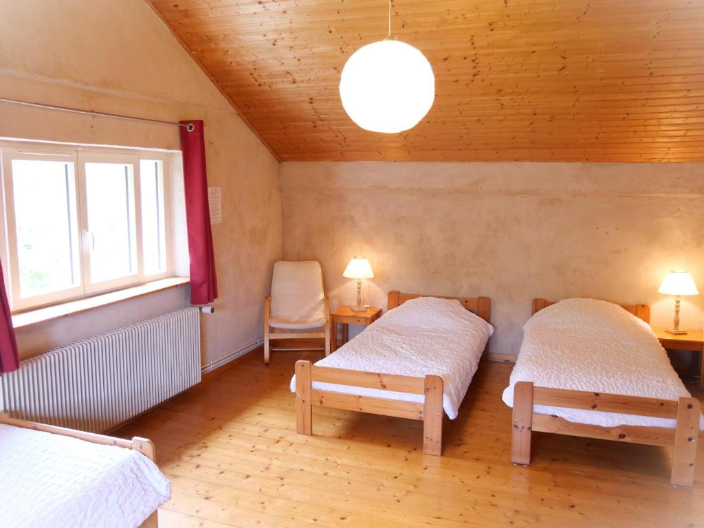 Łóżko lub łóżka w pokoju w obiekcie Domaine de Marmonfosse